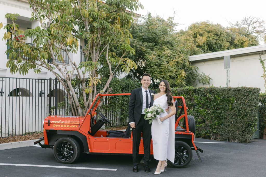 Bride and Groom standing in front of Moke in Santa Barbara